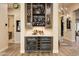 Wet bar with wine and beverage cooler, custom cabinetry, and quartz countertop at 30416 N 64Th St, Cave Creek, AZ 85331