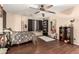 Bedroom with ceiling fan, dark wood floors, and built-in shelving at 31292 N Candlewood Dr, San Tan Valley, AZ 85143