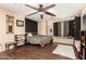 Bedroom with ceiling fan, dark wood floors, and ample natural light at 31292 N Candlewood Dr, San Tan Valley, AZ 85143