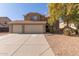 Two-story house with a three-car garage and landscaped front yard at 31292 N Candlewood Dr, San Tan Valley, AZ 85143