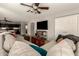 Spacious living room featuring a comfortable sectional sofa and a view into the kitchen at 31292 N Candlewood Dr, San Tan Valley, AZ 85143