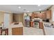 Bright kitchen with stainless steel appliances, including a range and refrigerator, next to the stairway at 3209 W Apollo Rd, Phoenix, AZ 85041