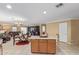 Open-concept living space with views of kitchen island, dining area and sofas, perfect for entertaining at 3209 W Apollo Rd, Phoenix, AZ 85041