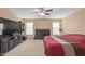 Comfortable main bedroom with dark wood dresser, a ceiling fan, and a large entertainment center at 3209 W Apollo Rd, Phoenix, AZ 85041