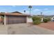 Brown double-door garage with a paved driveway at 3536 W Acapulco Ln, Phoenix, AZ 85053