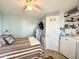 Bedroom with double bed, ceiling fan, and adjacent laundry at 356 S Felspar Dr, Apache Junction, AZ 85119