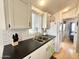 Well-equipped kitchen featuring white cabinets, a double sink, and modern appliances at 356 S Felspar Dr, Apache Junction, AZ 85119