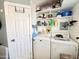 Laundry room with washer, dryer, and ample storage shelving at 356 S Felspar Dr, Apache Junction, AZ 85119