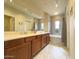 Bathroom featuring double sinks, a soaking tub, and elegant tile work at 3935 E Rough Rider Rd # 1191, Phoenix, AZ 85050