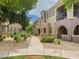 Townhome exteriors with walkway, featuring manicured landscaping and inviting entranceways at 3935 E Rough Rider Rd # 1191, Phoenix, AZ 85050