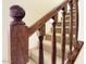 Close up of a beautiful wooden banister, spindles, and post, with carpeted stairs, providing a warm, inviting interior design element at 3935 E Rough Rider Rd # 1191, Phoenix, AZ 85050