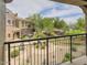 Balcony view overlooking the landscaped community courtyard with walking path, trees, and manicured desert vegetation, set against a blue sky at 3935 E Rough Rider Rd # 1191, Phoenix, AZ 85050