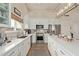 Clean kitchen featuring white cabinetry and a large island at 4220 E Thistle Landing Dr, Phoenix, AZ 85044