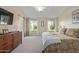 Main bedroom with sliding barn door and backyard access at 4220 E Thistle Landing Dr, Phoenix, AZ 85044