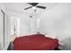 Red bedding in spacious bedroom with ceiling fan at 4334 N 19Th Dr, Phoenix, AZ 85015