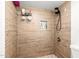 Clean shower with wood-look tile and built-in shelf at 4334 N 19Th Dr, Phoenix, AZ 85015