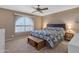 Spacious bedroom with a king-size bed and ceiling fan at 4725 E Capri Ave, Mesa, AZ 85206