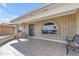 Front porch with tiled flooring, arched windows, and a metal security door at 4725 E Capri Ave, Mesa, AZ 85206