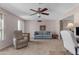 Relaxing living room features a light blue couch and ceiling fan at 4725 E Capri Ave, Mesa, AZ 85206