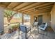 Back patio with a covered seating area, plants, decorative rug, and a large backyard with shade at 4903 W Palm Ln, Phoenix, AZ 85035