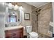 Bathroom with a walk-in shower, vanity with a sink and framed mirror, neutral walls and decor at 4903 W Palm Ln, Phoenix, AZ 85035