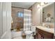 Bathroom with tiled shower, neutral walls, vanity with a sink and framed mirror at 4903 W Palm Ln, Phoenix, AZ 85035