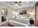 Bedroom featuring a king size bed, lamps, decor, an ensuite bathroom and a ceiling fan at 4903 W Palm Ln, Phoenix, AZ 85035