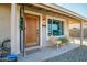 Inviting front entrance featuring a stylish wood door, comfortable seating, and well-kept landscaping at 4903 W Palm Ln, Phoenix, AZ 85035