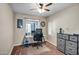 Home office with natural light, modern desk and chair, and a dresser for storage at 4903 W Palm Ln, Phoenix, AZ 85035