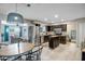 Modern kitchen with stainless steel appliances, dark cabinets, and an adjacent dining area at 4903 W Palm Ln, Phoenix, AZ 85035