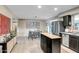 Contemporary kitchen featuring stainless steel appliances, a central island, and adjacent dining space at 4903 W Palm Ln, Phoenix, AZ 85035