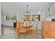 Bright dining area with wood flooring and view to backyard at 49201 N 24Th Ave, New River, AZ 85087