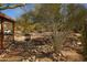 Landscaped front yard with fire pit and native plants at 49201 N 24Th Ave, New River, AZ 85087