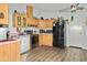 Kitchen features wood cabinets, black appliances, and laminate flooring at 49201 N 24Th Ave, New River, AZ 85087