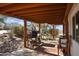 Covered patio with wooden beams, grill, and seating area at 49201 N 24Th Ave, New River, AZ 85087