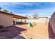 Backyard featuring a covered patio, desert landscaping, and play equipment at 5114 W Corrine Dr, Glendale, AZ 85304