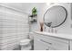 Bright bathroom featuring a modern vanity, round mirror, and decorative shelving unit at 5114 W Corrine Dr, Glendale, AZ 85304