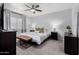 The main bedroom features carpet, ceiling fan, curtains, window and a large dresser at 5114 W Corrine Dr, Glendale, AZ 85304