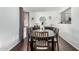 Cozy dining room with a dark wood table, comfortable seating, and decorative hanging plants at 5114 W Corrine Dr, Glendale, AZ 85304