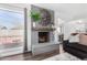 Stylish living room featuring a gray brick fireplace, large window, and partial view of the dining area at 5114 W Corrine Dr, Glendale, AZ 85304