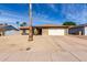 Attractive brick home featuring a two-car garage, desert landscaping, and a quaint front porch at 5114 W Corrine Dr, Glendale, AZ 85304