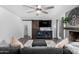 Spacious living room with a modern ceiling fan, fireplace, sliding barn door, and comfortable furnishings at 5114 W Corrine Dr, Glendale, AZ 85304