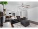 Open-concept living room showcases a brick fireplace, ceiling fan, comfortable seating, and partial kitchen view at 5114 W Corrine Dr, Glendale, AZ 85304