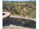 Stone wall with fire pit and scenic mountain views at 55823 N 329Th Dr, Wickenburg, AZ 85390