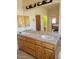 Bathroom vanity features double sinks, wood cabinets, and stylish lighting at 55823 N 329Th Dr, Wickenburg, AZ 85390