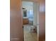 Bright bathroom featuring tiled floors, soaking tub, and wooden vanity at 55823 N 329Th Dr, Wickenburg, AZ 85390