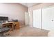 Bright bedroom with wood desk and double door closet at 5613 N Laguna Ct, Litchfield Park, AZ 85340