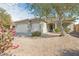 Single-story home with a two-car garage and desert landscaping at 5613 N Laguna Ct, Litchfield Park, AZ 85340