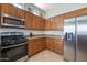 Modern kitchen with stainless steel appliances and granite countertops at 5613 N Laguna Ct, Litchfield Park, AZ 85340