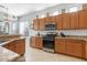 Kitchen with granite countertops and wood cabinets at 5613 N Laguna Ct, Litchfield Park, AZ 85340